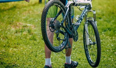 cyclist holds the broken mountain bike