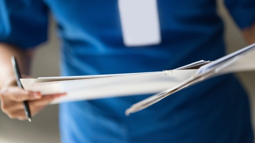 Nurse checking patient document
