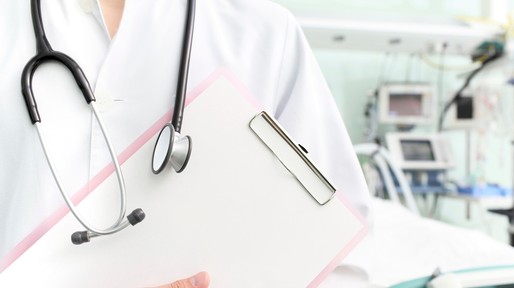 Doctor with clipboard and stethoscope in hospital