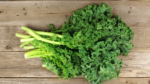 Bunch of kale over a wooden background
