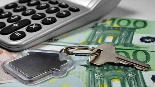 Calculator, money and house key