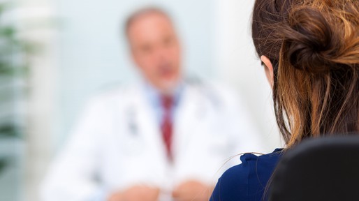 Doctor talking to a patient in his office