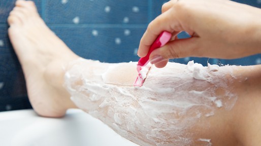 female hand shaving leg