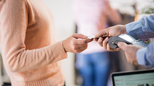 Man giving credit card to woman