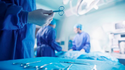 Doctors performing surgery in hospital operating room