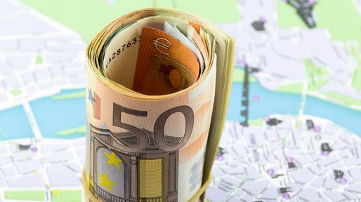 Fifty Euro rolled up on a map as a background