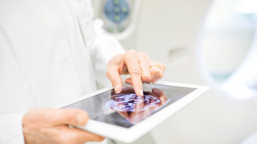 Doctor analyzing X-ray image in digital tablet