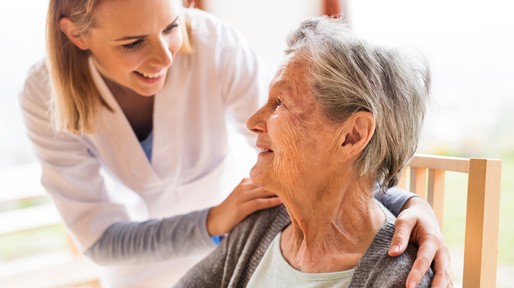 Health visitor and a senior woman during home visit.