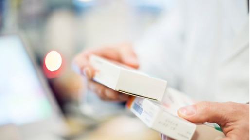 cropped-image-of-pharmacist-holding-medicines-picture-id669895608