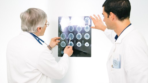 Doctors Consult Over An MRI Scan Of The Brain