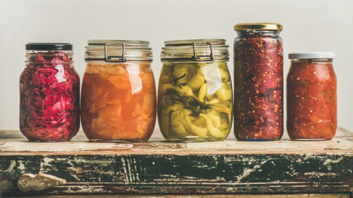 autumn-pickled-colorful-vegetables-in-jars-placed-in-line-picture-id860309510